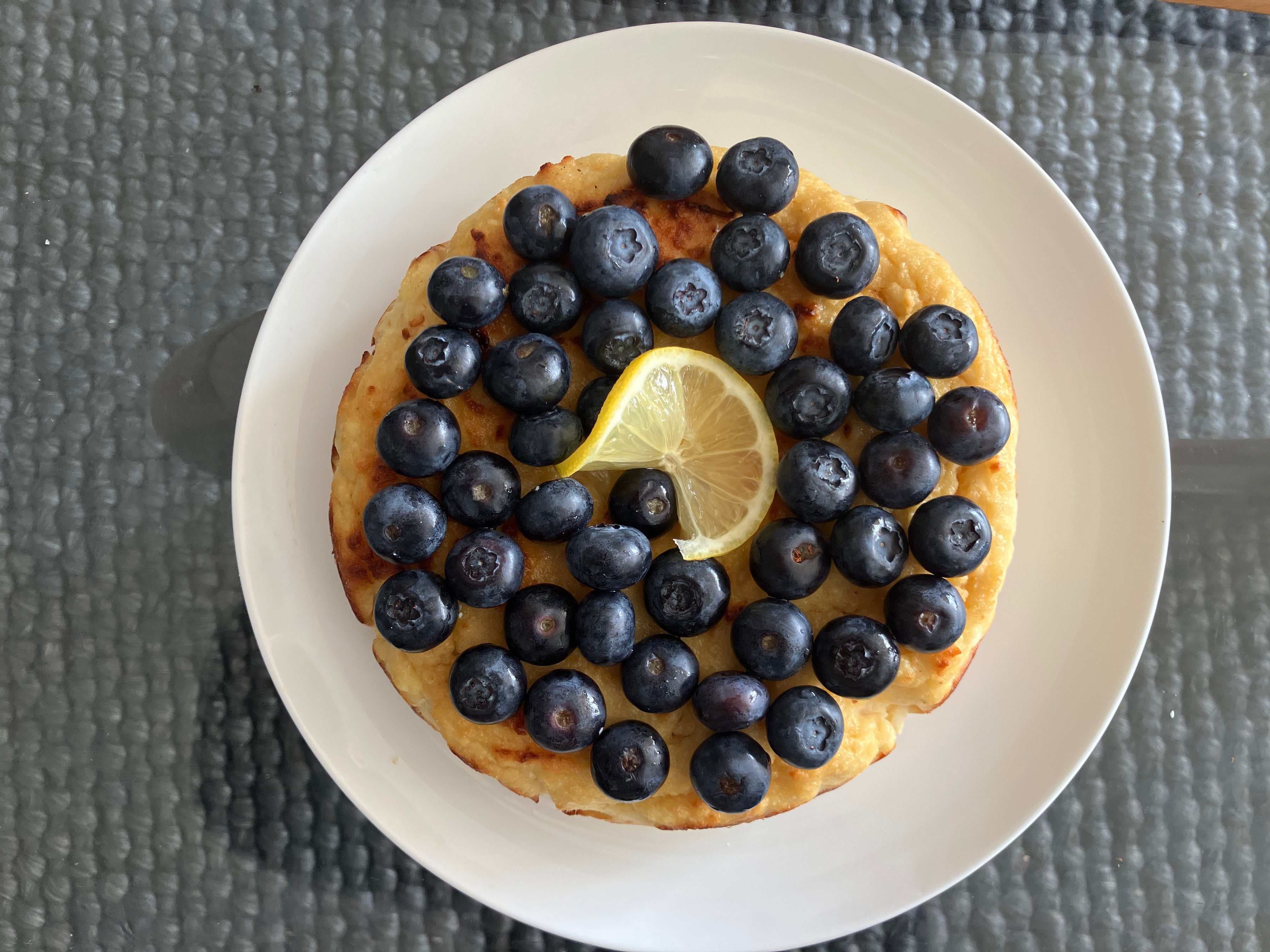 Fresh Sicilian-style lemon and ricotta cake on a ceramic plate